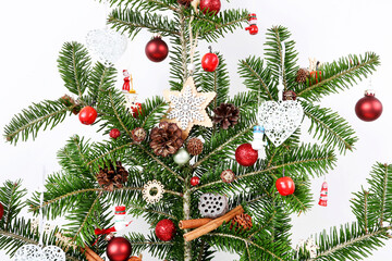 Naklejka na ściany i meble Christmas tree decorated with baubles and miniature toys.