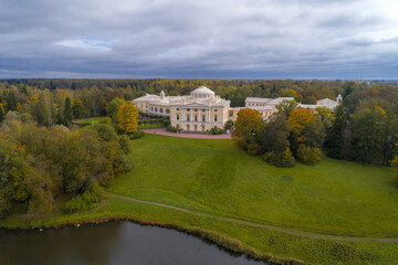 Pavlovsk Palace in autumn landscape on cloudy October day (aerial photography). Suburbs of St. Petersburg, Russia
