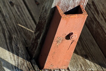 Wood and metal construction with nut on a Sunny day
