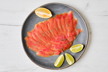 Top view of smoked thin slices of salmon fillet