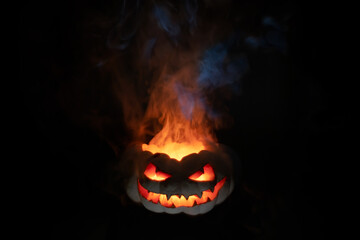 A terrible pumpkin with burning eyes, a cloud of smoke enveloped it. Halloween is coming soon
