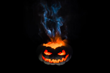 A terrible pumpkin with burning eyes, a cloud of smoke enveloped it. Halloween is coming soon