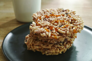 Thai sweet dessert crispy rice cracker with sugar cane baking watermelon juice dressing caramel on plate