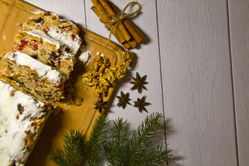 Christmas stollen on a wooden background. Top view. Stollen for Christmas. Traditional Christmas festive confectionery dessert.