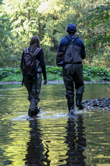 Naklejka premium Young woman learning to fly fishing with a profesional guide