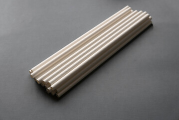 Selective focus of paper straw for drinks on grey background.
