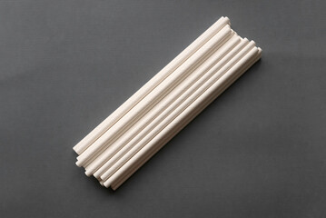 Selective focus of paper straw for drinks on grey background.