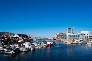 Fototapeta na wymiar Ships and boats lying in the port of Bodø on clear winter day