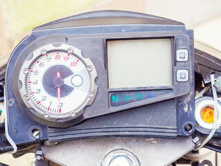 Motorcycle speedometer with arrows numbers and screen. Photo close-up in full screen