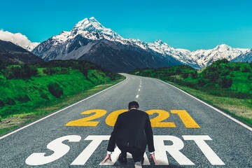 The 2021 New Year journey and future vision concept . Businessman traveling on highway road leading...