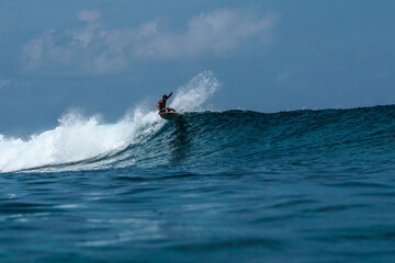 Surfer on perfect blue aquamarine wave, empty line up, perfect for surfing, clean water, Indian Ocean