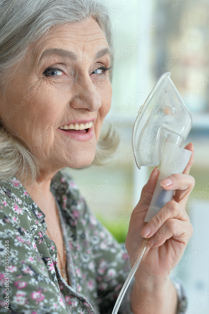 Sticker Close-up portrait of elderly woman with flu inhalation