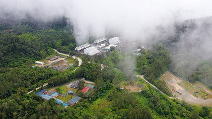 Fototapeta na wymiar Geotermal power plant on Mount Apo. Geothermal station with steam and pipes in the rainforest. Mindanao, Philippines.