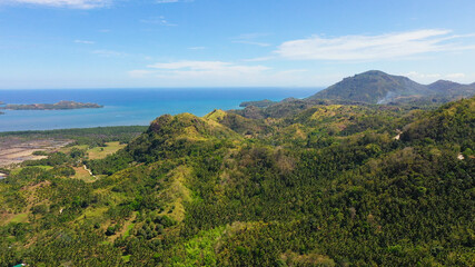 The mountains and hills with tropical forest with blue sea. Tropical landscape, Mindanao,...