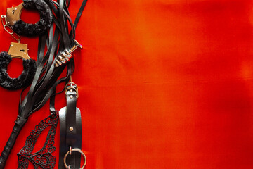 Set of toys for adults: handcuffs, anal plug, mask, whip. Space for text