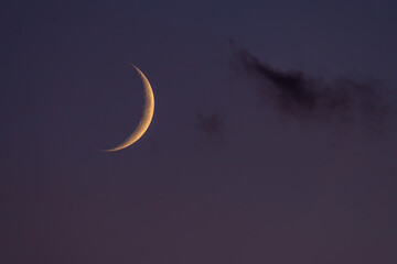 Obraz na płótnie Canvas Waxing crescent moon in the evening sky.