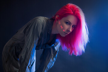 Cyberpunk and futurism, concept. A young woman with pink hair and a jumpsuit, human augmentation, © Ulia Koltyrina