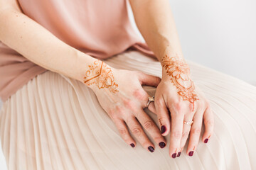 Girl of European appearance, henna drawing on hands, mahendi, girl in light clothes, yoga, spiritual development