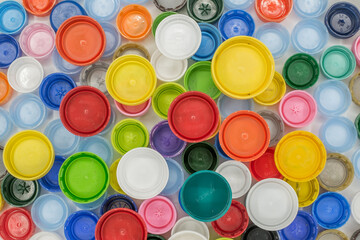 Recycled Multicolored Plastic Bottle Caps on white background