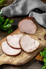 Meatloaf with herbs on a wooden Board on a brown wooden table. Baked meat. Rustic style	