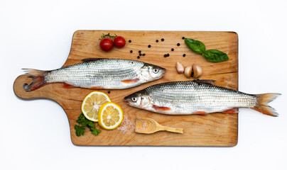 Fish with aromatic herbs, spices and vegetables - healthy food, diet or cooking concept