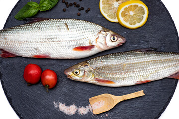 Fish with aromatic herbs, spices and vegetables - healthy food, diet or cooking concept