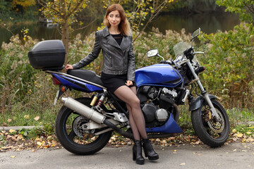 Fototapeta na wymiar Beautiful woman sitting on the motorcycle