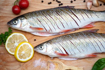 Fish with aromatic herbs, spices and vegetables - healthy food, diet or cooking concept