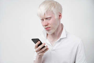albinism albino man in studio dressed t-shirt isolated on a white background. abnormal deviations. unusual appearance