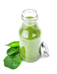 Homemade spinach smoothie isolated on white (close up; selective focus)