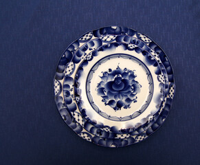 Plates with a blue pattern, festive table setting. Close-up of the table set for dinner at home during the holiday season. Gzhel