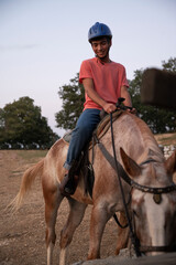 Fototapeta premium A Man Sitting on a Horse when the Horse Eating. Ranch Concept Photography