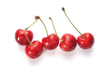 Red cherries with water droplets, close-up. Isolated on white background.