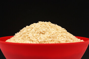healthy raw white rice served in a red bowl 