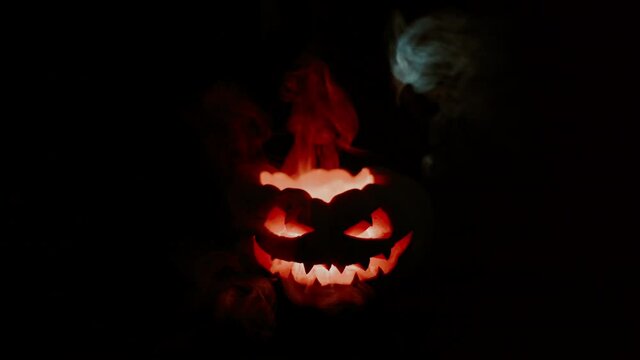 A terrible pumpkin explodes, smoke hovers from his eyes. Halloween is coming