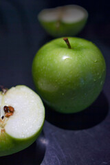 a green apple on the black background
