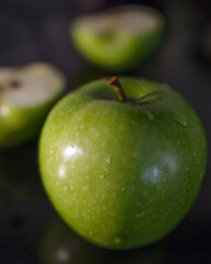a green apple on the black background