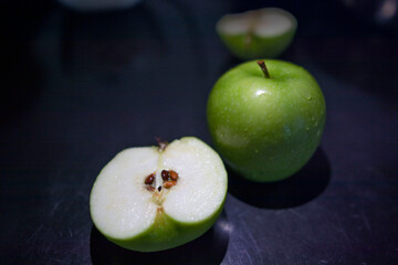 a green apple on the black background