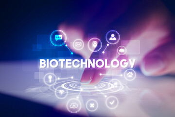 Finger touching tablet with web technology icons and BIOTECHNOLOGY inscription, web technology concept