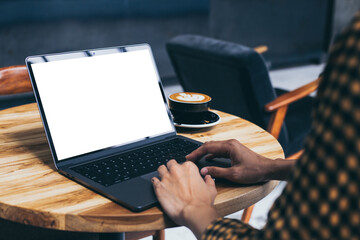 computer blank screen mockup.hand woman work using laptop with white background for advertising,contact business search information on desk at coffee shop.marketing and creative design