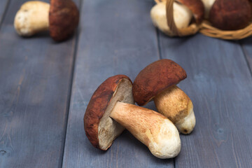 mushrooms scattered from a basket on a wooden table, picking mushrooms