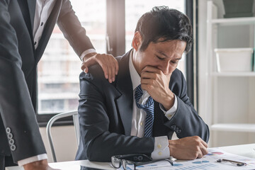 Colleague touch shoulder encouraging young businessman after work failure.