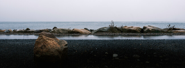 Panoramic Seascape with Stones over Shining Sun Bikeway in Falmouth on Cape Cod