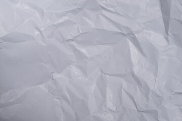 Obraz premium macro photo of white (gift) wrapping paper, crumpled paper texture or surface.