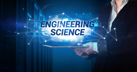 Young business person working on tablet and shows the inscription: ENGINEERING SCIENCE