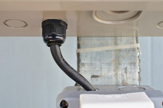 Close up shot of a cable gland with lock nut installed to a power panel. 