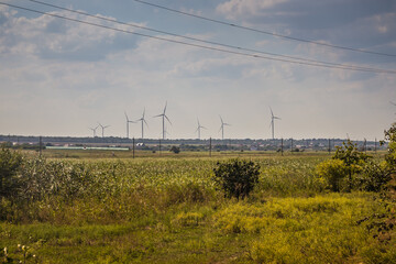 Windwheels and a field in rural Ukraine. Wind farm near the village