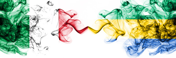 Italy vs Gabon, Gabonese smoky mystic flags placed side by side. Thick colored silky abstract smoke...