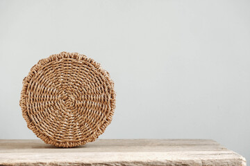 Fototapeta premium Round wicker basket on a old wooden table. Copy, empty space for text