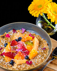 A healthy bowl of muesli and fruit for a colorful fresh breakfast